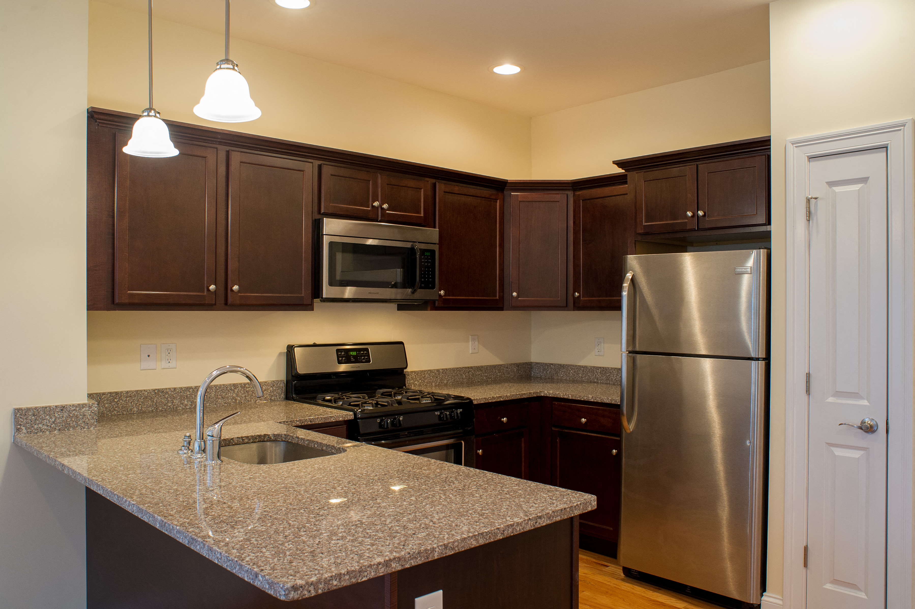 a kitchen with granite counter tops and stainless steel appliances